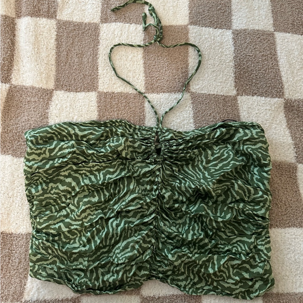 Super cute silk like top that ties around neck. You can dress up or down.
